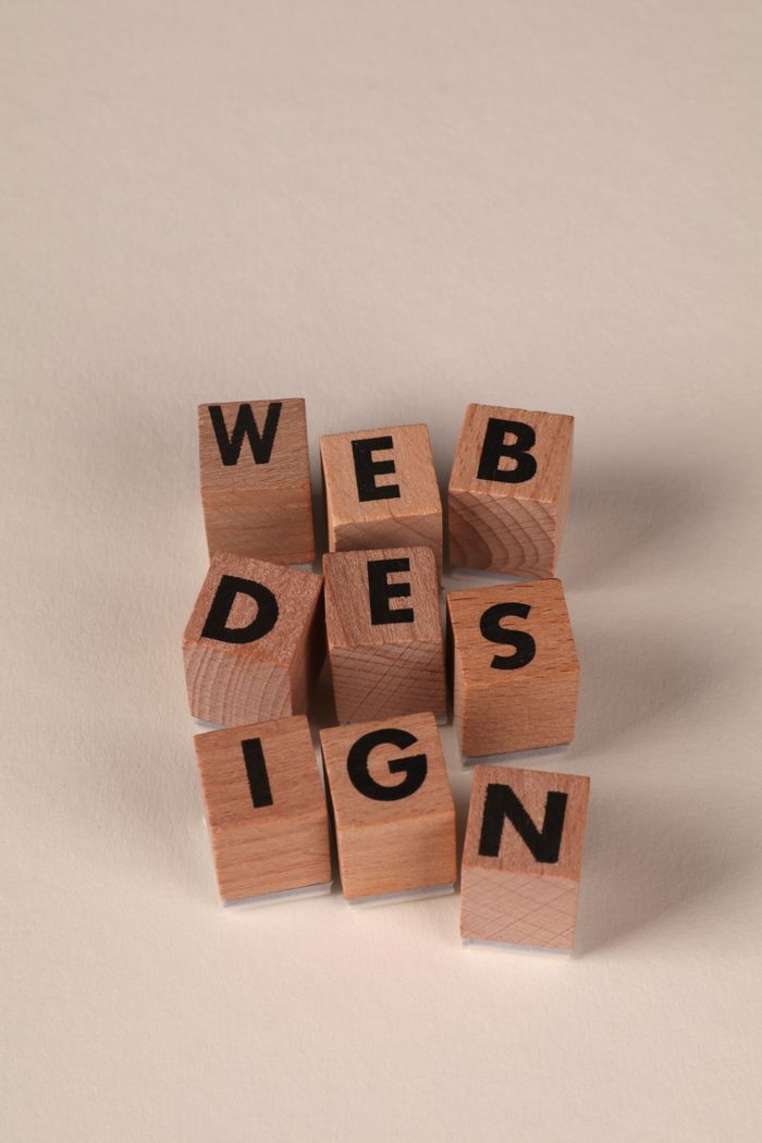 creative-01 Wooden blocks arranged to spell Web Design. Perfect for creative, digital content themes.